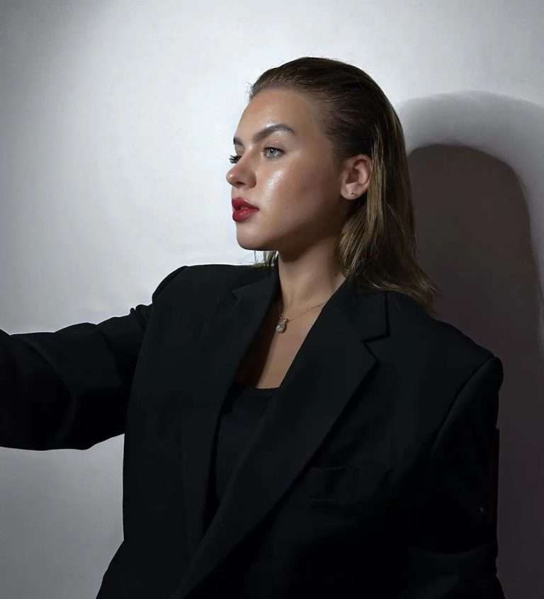 Shannah Lindh applying bold red lipstick